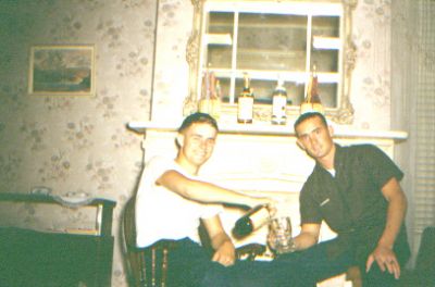 In 1962 I had just returned to Charleston from a "Med Cruise" on the 
U.S.S. Eugene A. Greene DDR711. I was sent to Westwego Louisiana and 
assigned to the U.S.S. Semmes DDG18 that was being built in the Avondale
Shipyards. Shortly after I got there, Mike Dunn, another ET was assigned.
We were given finances for food and houseing as there were no service 
quarters in the area. Mike and I ended up renting the upper floor of a 
two story house across the river from New Orleans. There was a balconly 
off one of the rooms and on Halloween night, Mike and I filled up a bunch of 
balloons with water and chunked them at the kids as they roamed the 
neighborhood collecting candy. Boy was that a hoot! This photo was mid 
Nov '62, my 21st birthday. Actually Mike and I didn't drink much.
I think we dug those bottles out of a dumpster just for "decoration".
The cock roaches there were so big, that when you stepped on one, it gave 
off a loud "pop". Mike, and another ET, John "Moose" Brinkheide and I were 
part of the skeleton crew that steamed out of New Orleans to Charleston. 
 Alex


