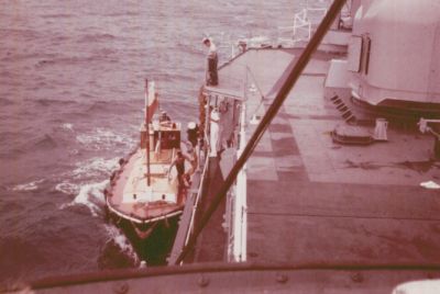 Here's a nice shot of the pilot boat that brought us into Bermuda.   
Would have to check my files to narrow the date down.   
Looks like Tarrence again (?) on the 01 level looking down....(didn't that 
fellow do any work?? ha,ha), 
one of our sharp looking officers, and a few other people I can't make out.   
You guys start getting your Semmes photos together now, so you can bring 
them to the reunion. 

Mitch
