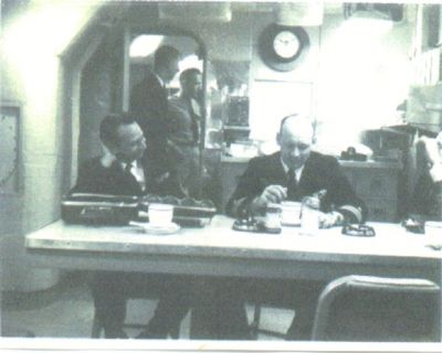 Seated , Paul Stark, and Capt. Emerson. In doorway Underwood, in Blues, and Cunningham
