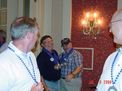 Ted McCourtney and Eric Bruno watching Jack Cistriano and Ron Beinhaur have 
a good time passing out their Navy beads.
