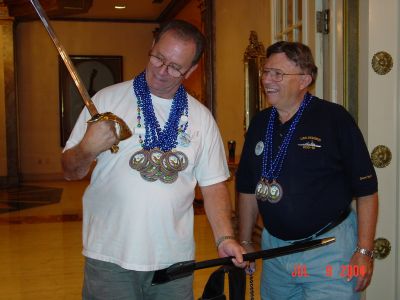Charlie Layus and Jack Cistriano admire the sword brought by Byron Personett.
